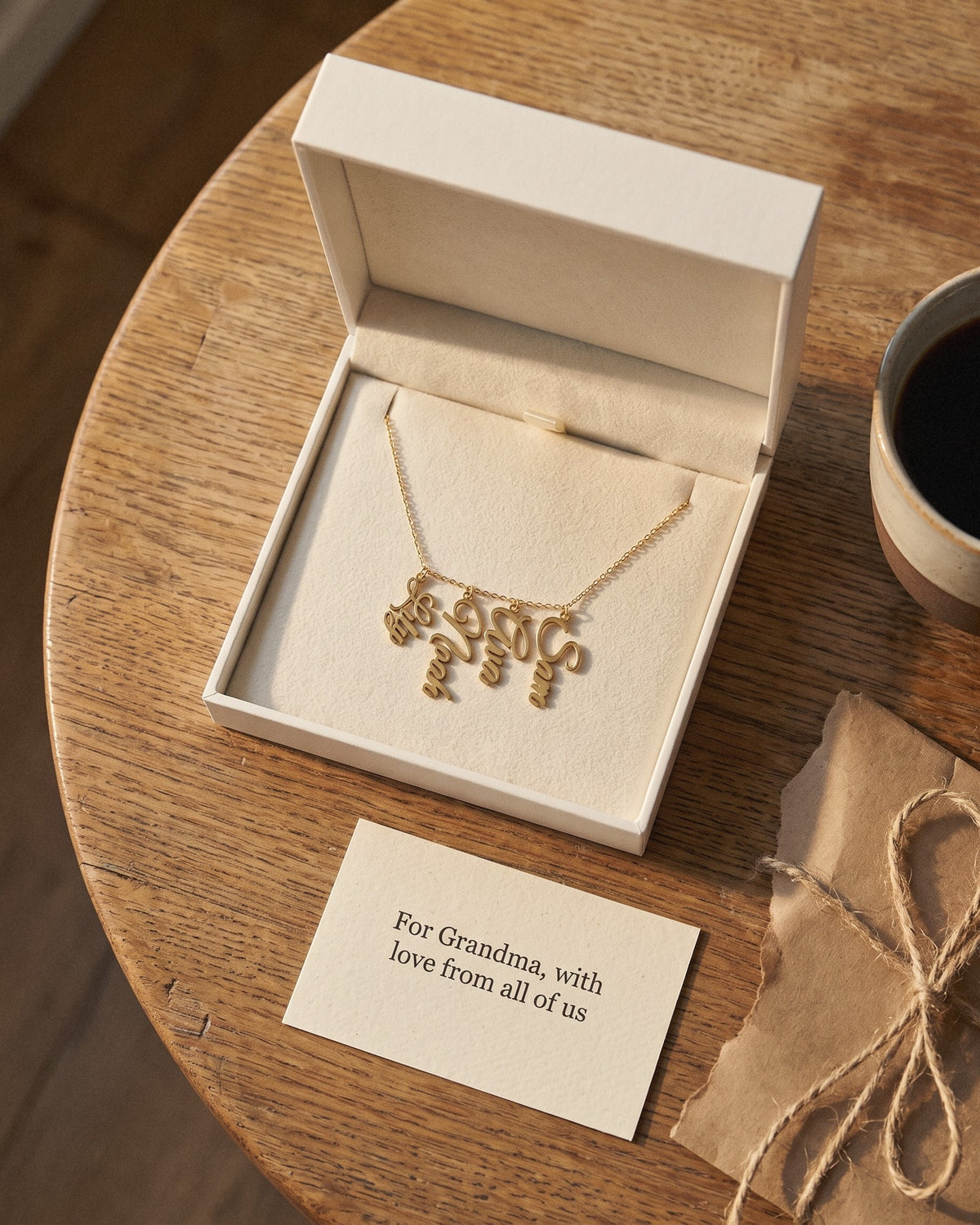The grandkids' names necklace in its gift box with a printed card